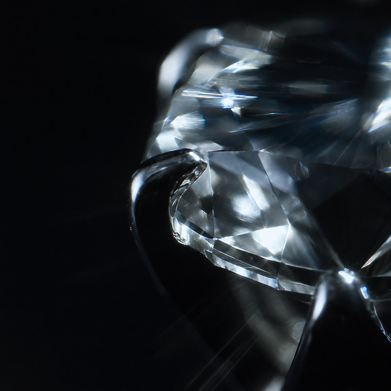 Macro of a faceted colourless stone, backlit
